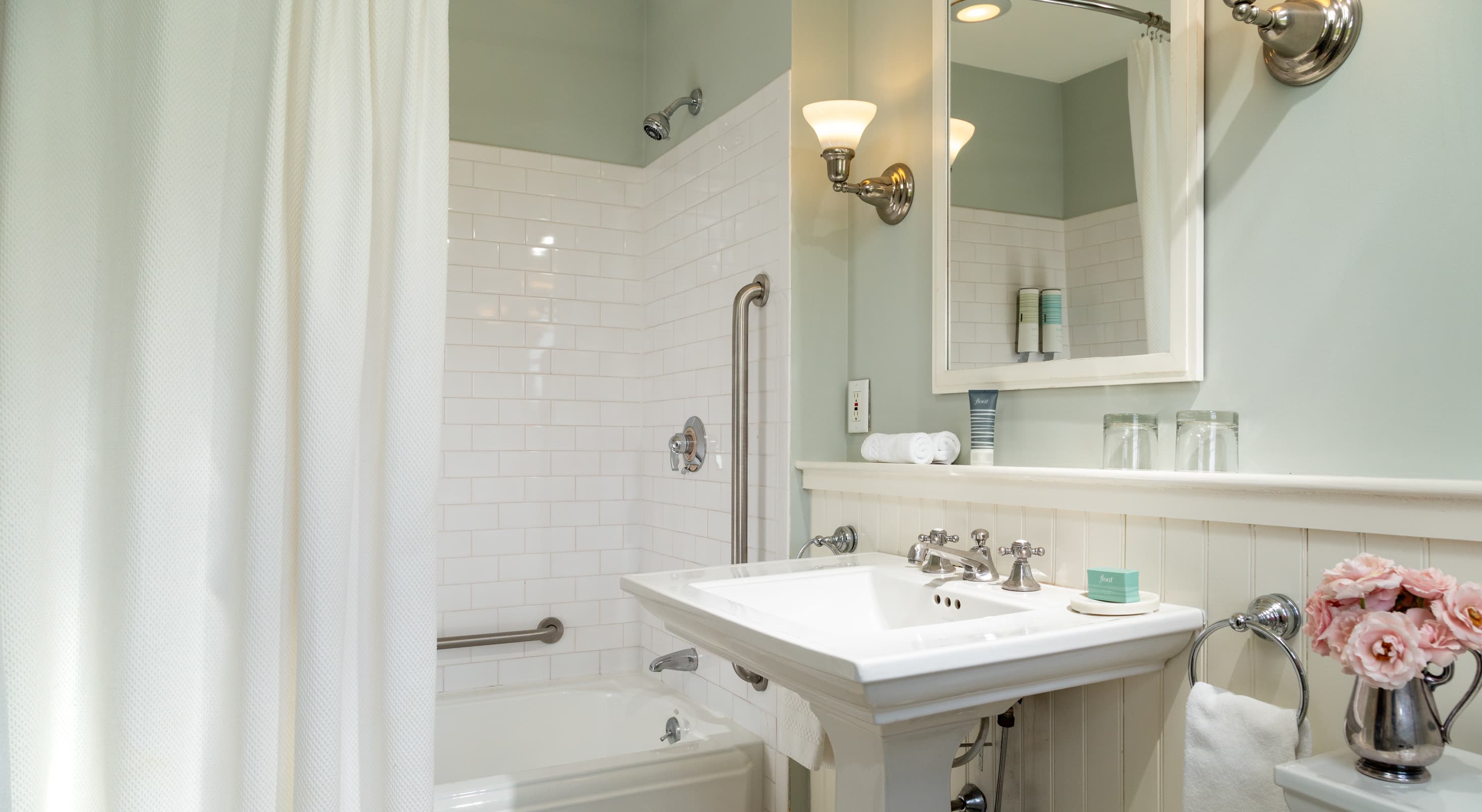 Ipswich, MA lodging with sunny private bathroom, pedestal sink and tub/shower combo