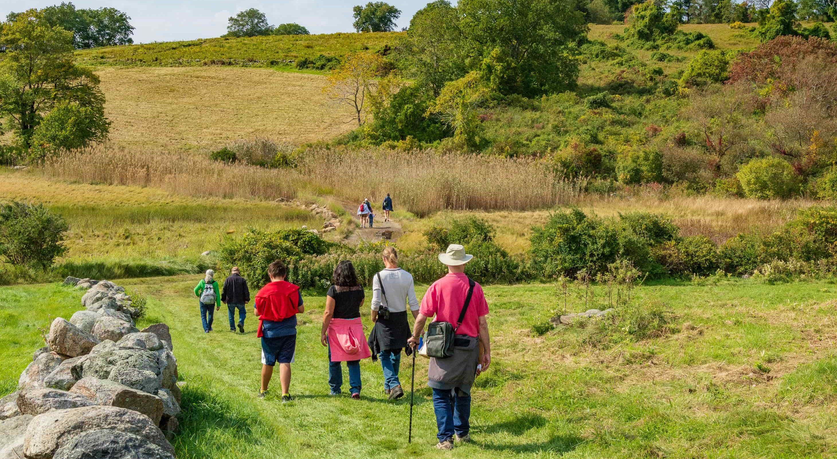 Group hiking through the Crane Estate property on Choate Island trail