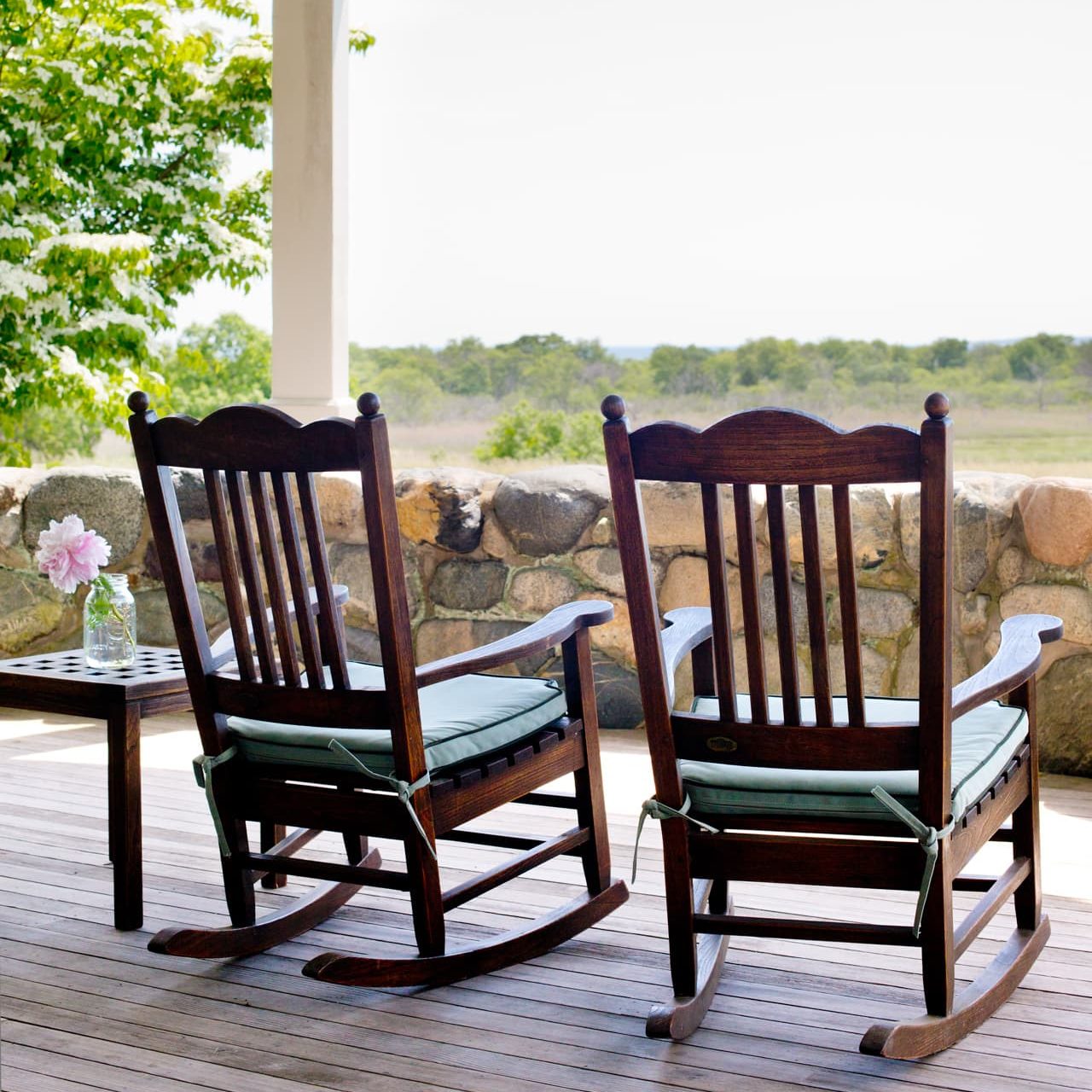 Rocking chairs on the porch with view looking out to sea