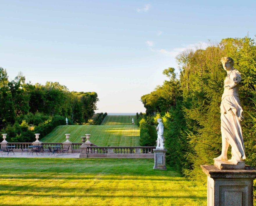 View of the garden lined with statues at the Great House of the Crane Estate